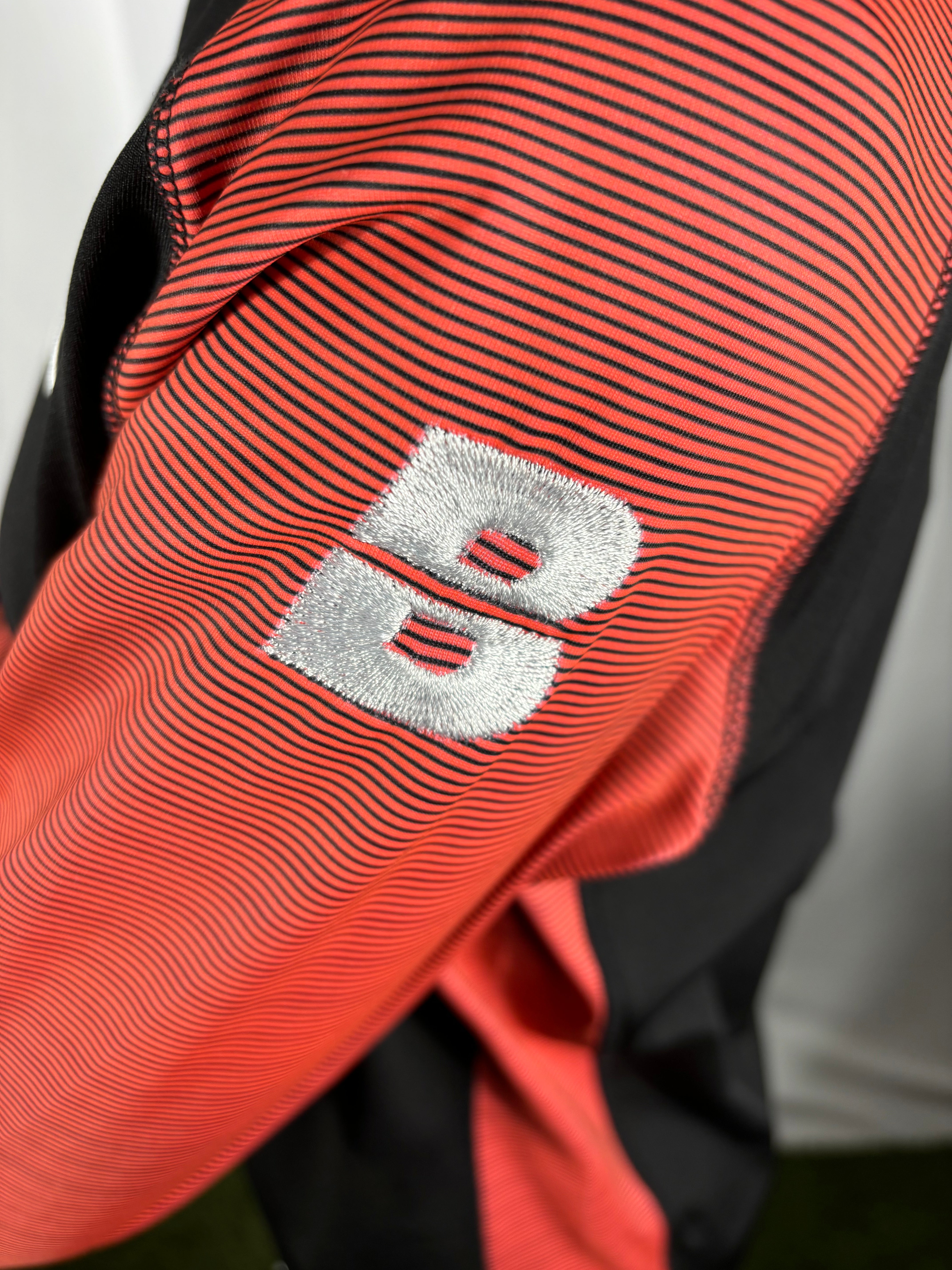 PERFORMANCE QUARTER ZIP TOP BLACK/CORAL